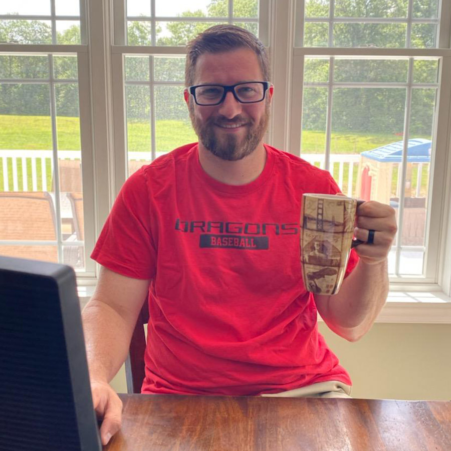 David sitting with a cup of coffee in front of a computer