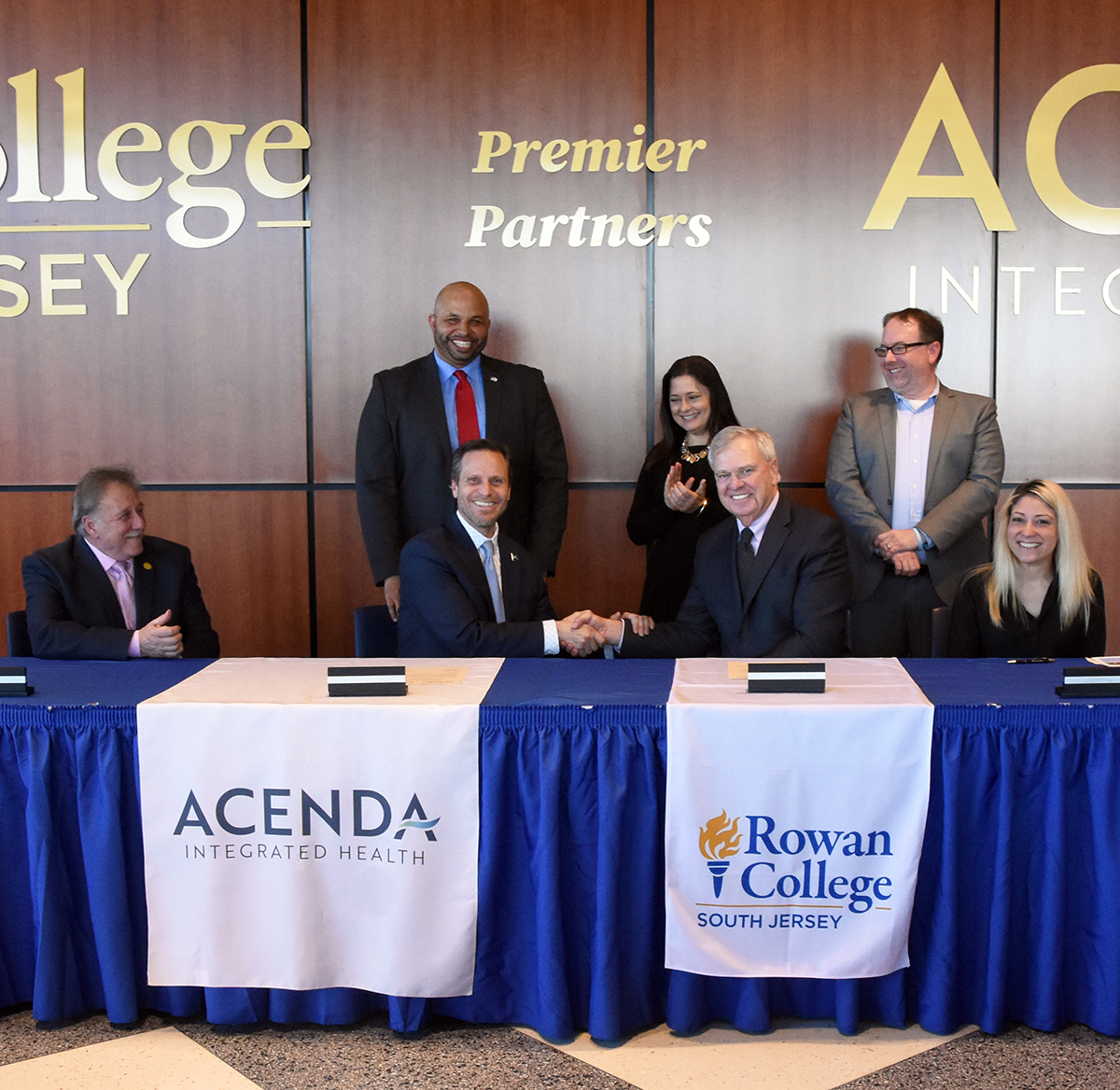 Local government officials, administrators, educators, and health care leaders at the signing of the partnership