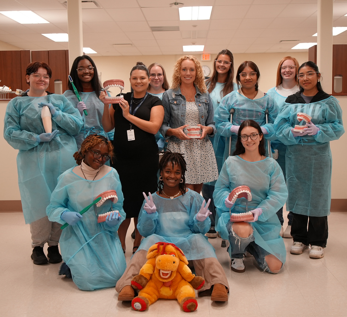 RSCJ Dental students posing for a group shot with Dental props