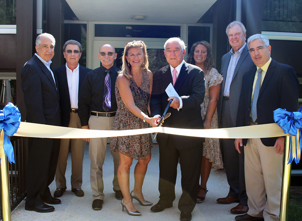 Photo of Ribbon being cut at dedication event