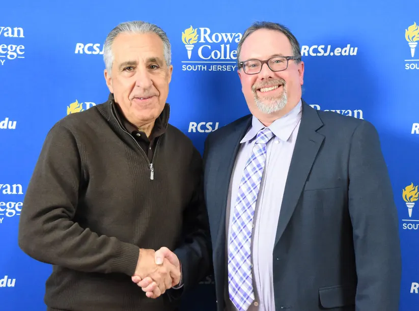 Gene Concordia, RCSJ Board of Trustees Chairperson shakes Brenden B. Rickards hand after Rickards being announced the 2nd President of RCSJ.