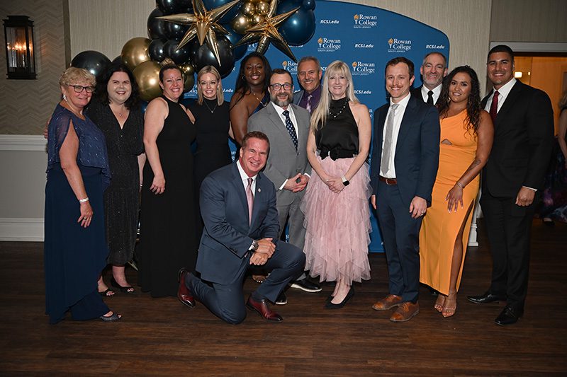 ACE leadership pose for photo at Gala event.