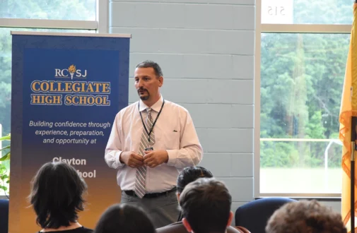 Employee from a Collegiate High School partner school talking to new Collegiate Students