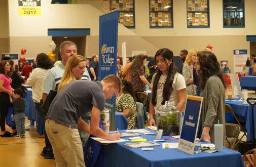 Guests at an RCSJ open house engaging with an RCSJ staff memeber