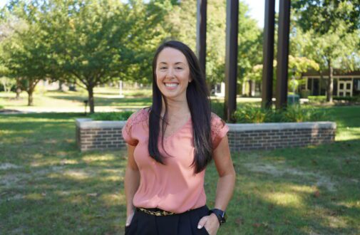 Rowan College of South Jersey–Cumberland's Assistant Athletic Director, Jeanna DuBois, stands near the clocktower as she shares her breast cancer experience.