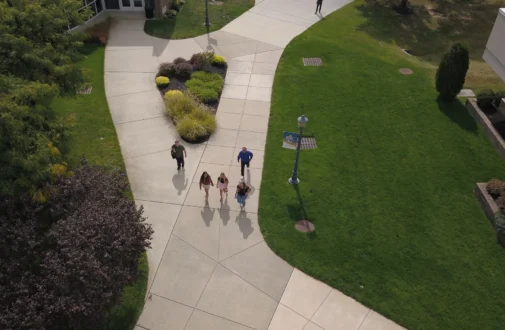 Aerial photo of students walking on a campus sidewalk