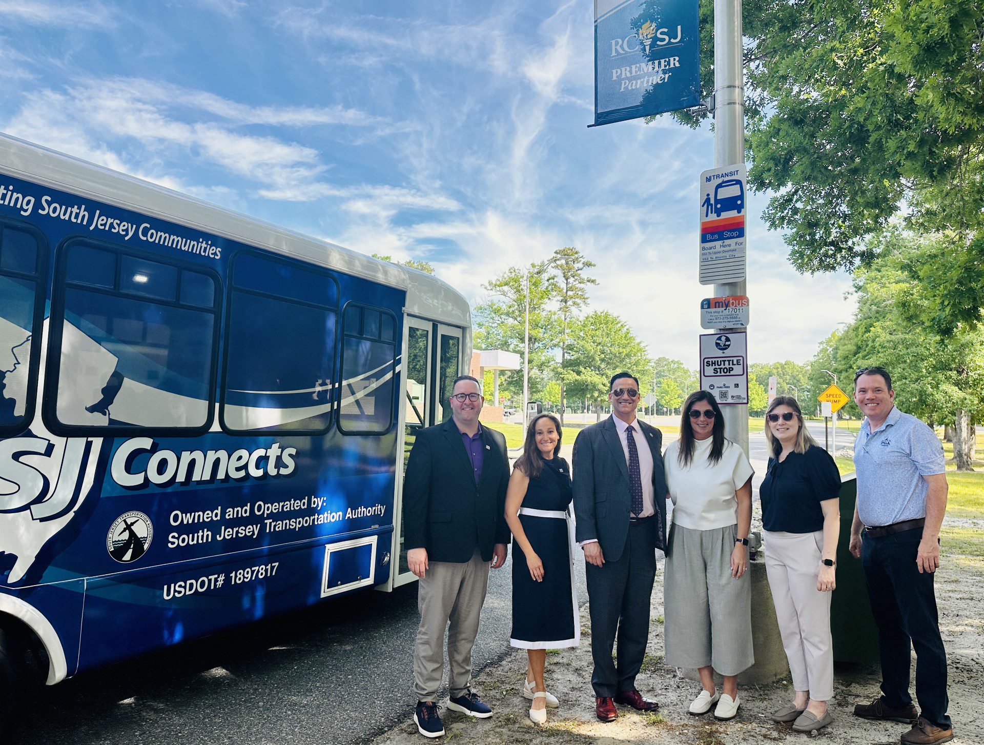 New Jersey state officials, chamber of commerce, SJTA and RCSJ officials pose at a bus stop on the RCSJ–Cumberland campus next to a SJ Connects bus. L-R: Assemblyman Cody Miller; RCSJ Vice President Communications, Marketing and Enrollment Management Susan Nardelli; NJ State Senator Michael Testa;, President & CEO Chamber of Commerce Southern New Jersey Christina M. Renna; Director, Government Affairs Chamber of Commerce Southern New Jersey Hilary Chebra; Executive Director South Jersey Transportation Authority Stephen Dougherty.