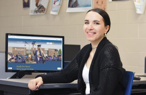 Student sits in computer lab looking at RCSJ's new website.