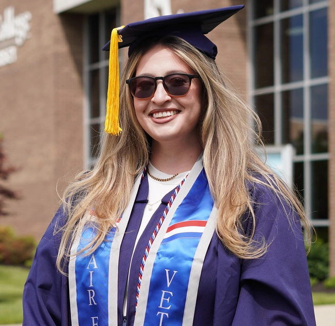 RCSJ military student poses at May 2026 graduation as part of the Commencement platform - being honored for her service to our country.